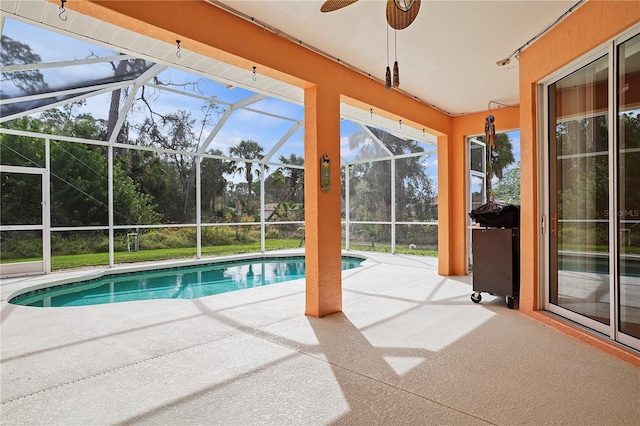 view of pool with a patio, a grill, ceiling fan, and glass enclosure