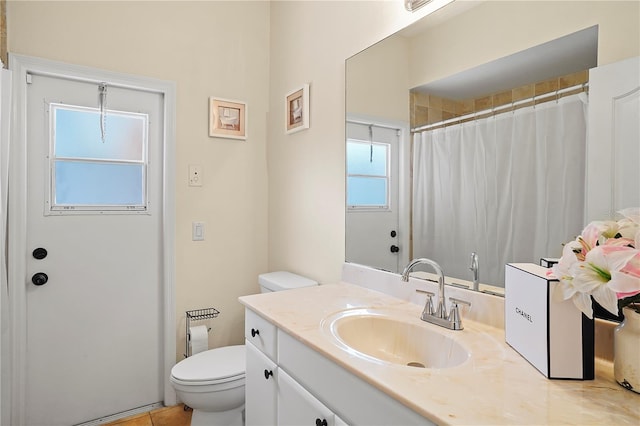 bathroom featuring oversized vanity, toilet, and tile flooring