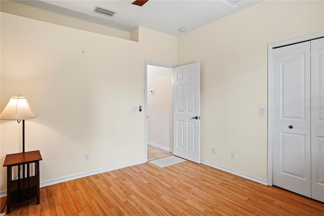 unfurnished bedroom featuring a closet and light hardwood / wood-style floors