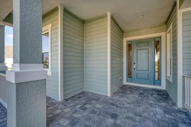 property entrance with covered porch