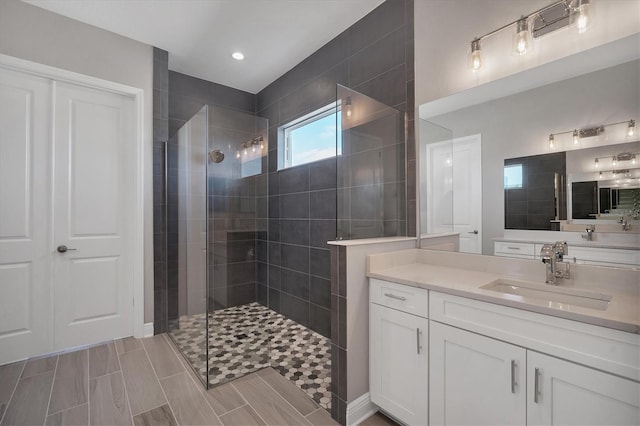 bathroom featuring vanity and tiled shower