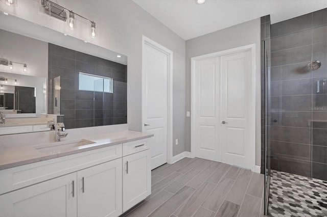 bathroom with a shower with door and vanity