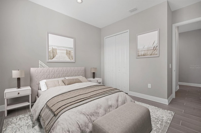 bedroom featuring dark hardwood / wood-style flooring and a closet