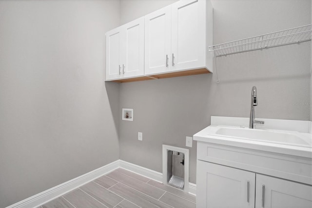 laundry room featuring washer hookup, cabinets, and sink