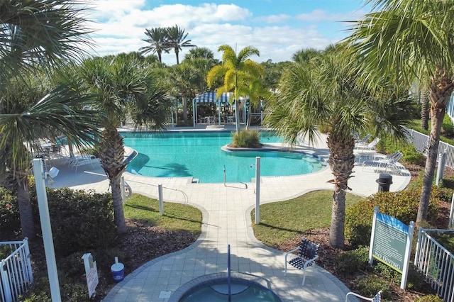 view of swimming pool featuring a community hot tub and a patio area