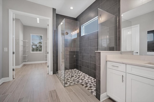 bathroom featuring vanity and a tile shower