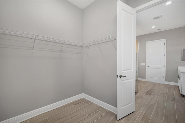 walk in closet featuring light hardwood / wood-style flooring