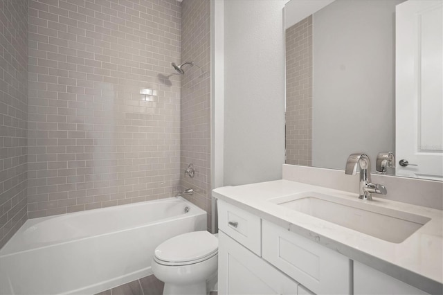 full bathroom featuring vanity, toilet, and tiled shower / bath