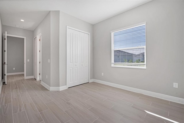 unfurnished bedroom featuring a closet and light hardwood / wood-style flooring