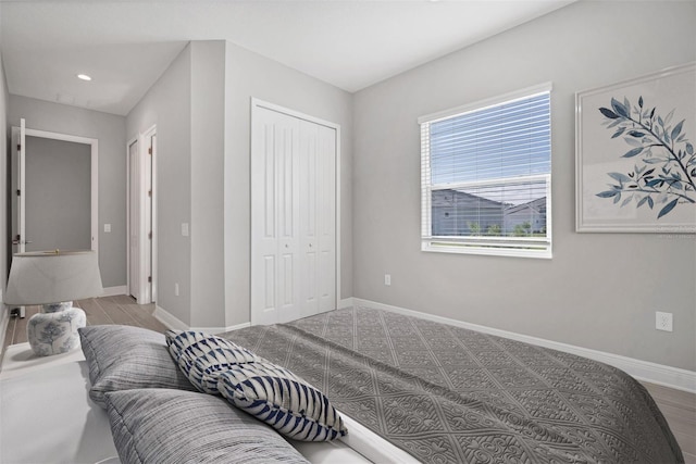 bedroom featuring a closet and light hardwood / wood-style flooring