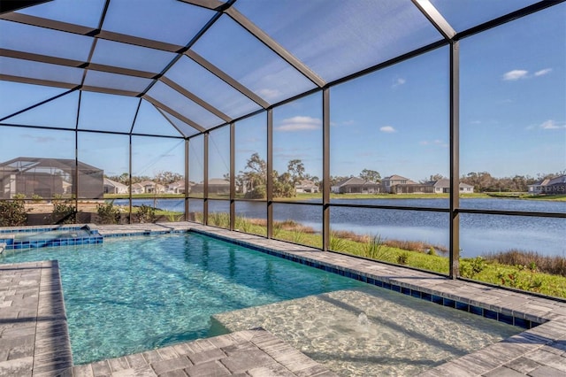 view of pool with glass enclosure and a water view