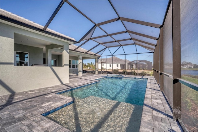 view of pool featuring glass enclosure and a patio area