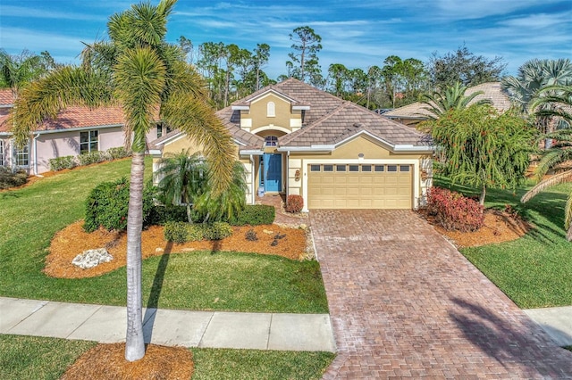 view of front of home featuring a front yard and a garage