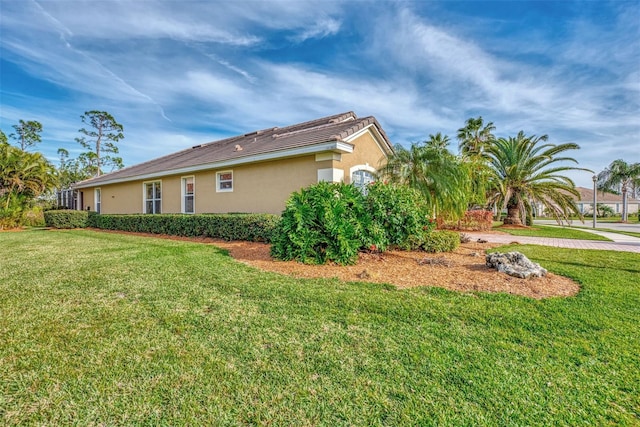 view of property exterior with a yard