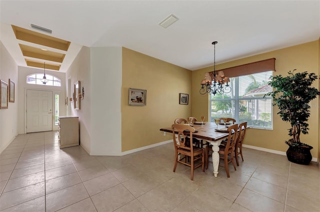 tiled dining area with a notable chandelier and plenty of natural light