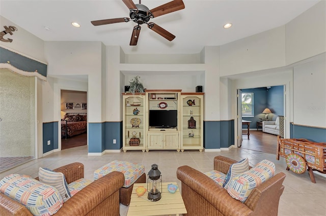 living room with light tile floors and ceiling fan