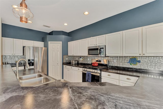 kitchen featuring white cabinets, backsplash, stainless steel appliances, and sink