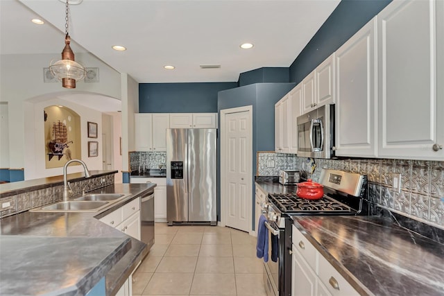 kitchen with stainless steel counters, hanging light fixtures, stainless steel appliances, and white cabinetry