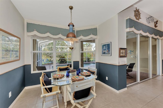 tiled dining space with an inviting chandelier