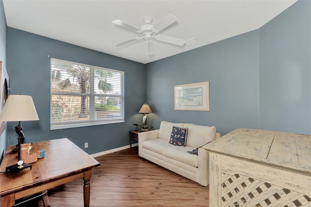 home office with wood-type flooring and ceiling fan