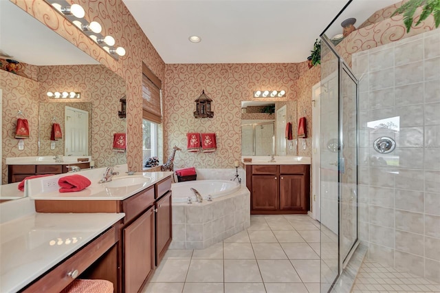 bathroom with double sink vanity, tile flooring, and independent shower and bath