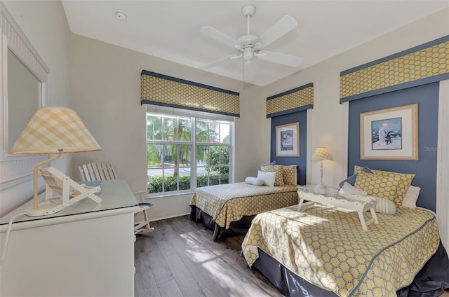 bedroom with ceiling fan and dark hardwood / wood-style floors