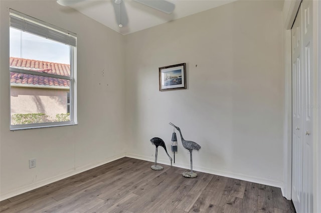 empty room featuring ceiling fan and dark hardwood / wood-style flooring