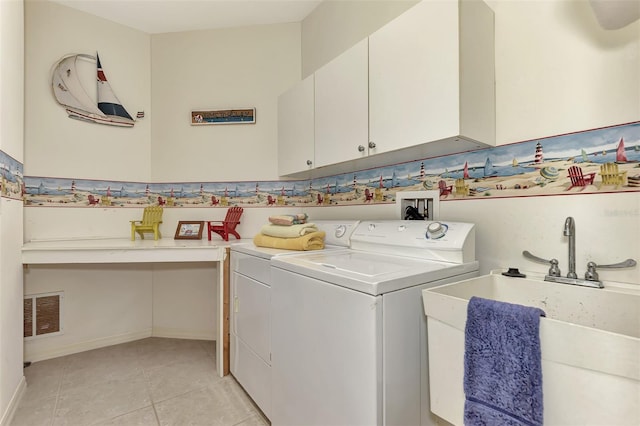 clothes washing area with washer hookup, light tile floors, cabinets, washing machine and dryer, and sink