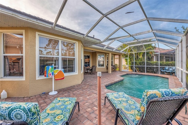 view of pool featuring a lanai and a patio