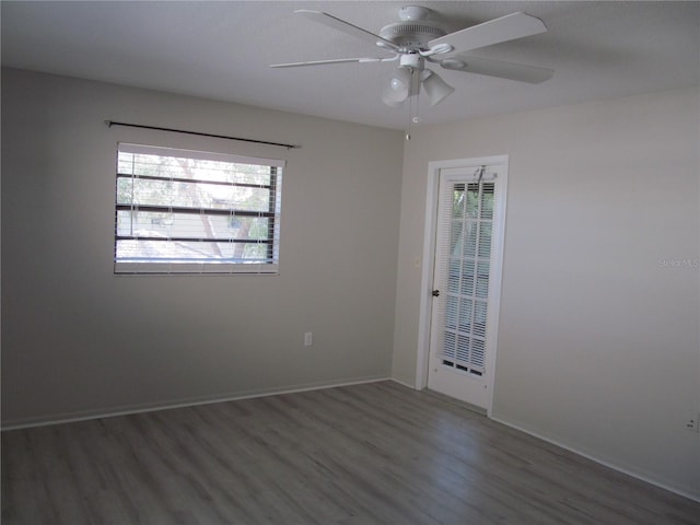 unfurnished room featuring ceiling fan and dark wood-type flooring