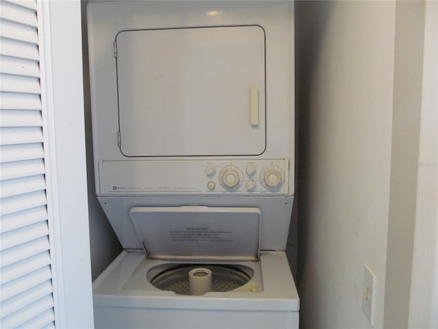 laundry area with stacked washer / dryer