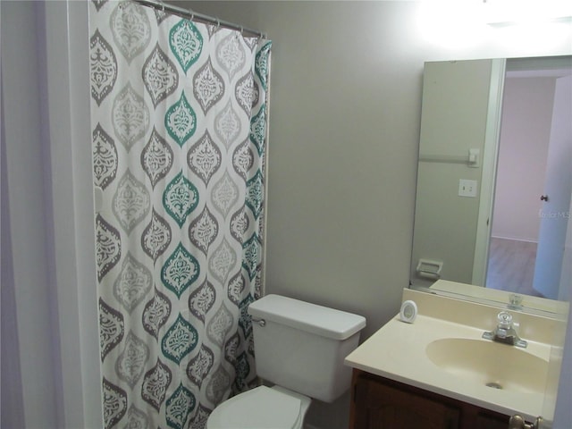 bathroom with toilet and vanity