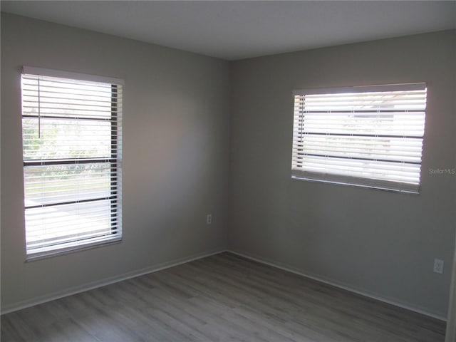 spare room with dark wood-type flooring