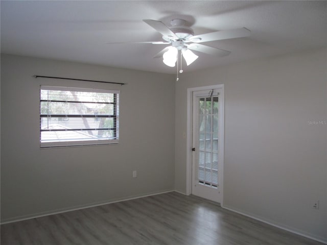 unfurnished room featuring dark hardwood / wood-style flooring and ceiling fan