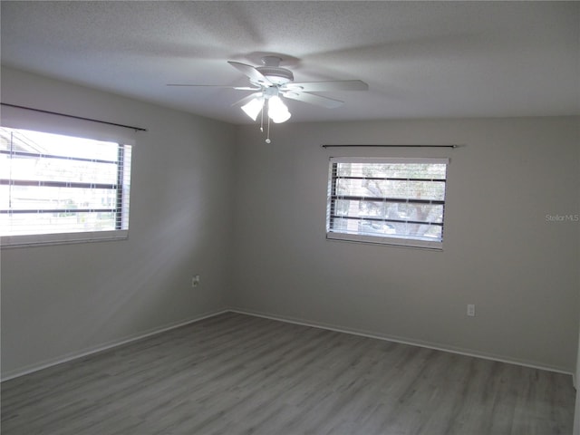 unfurnished room with a textured ceiling, ceiling fan, and hardwood / wood-style flooring