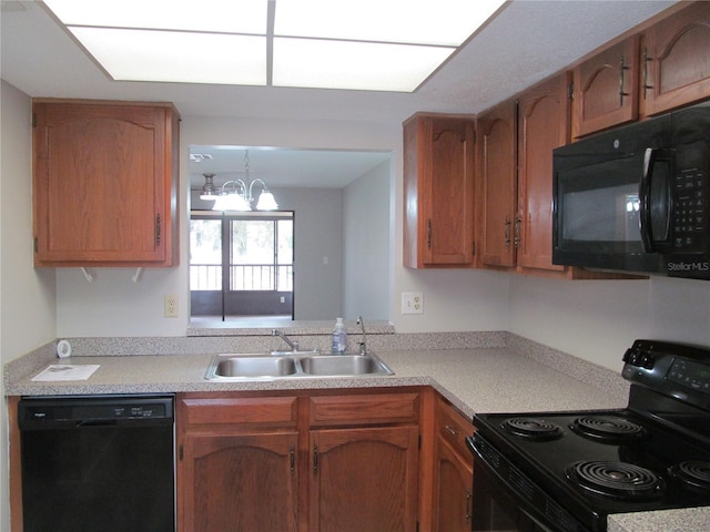 kitchen featuring an inviting chandelier, sink, and black appliances