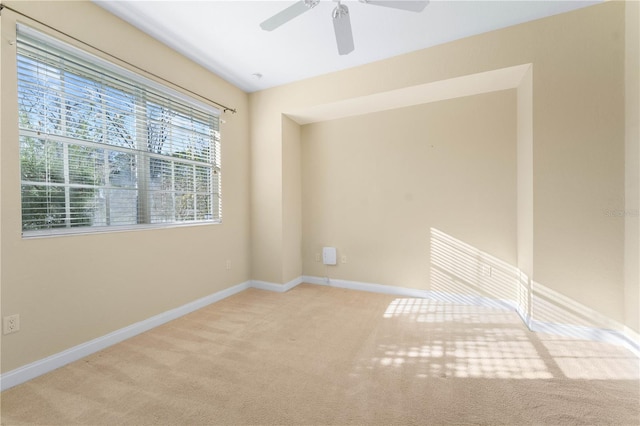 empty room featuring light colored carpet and ceiling fan