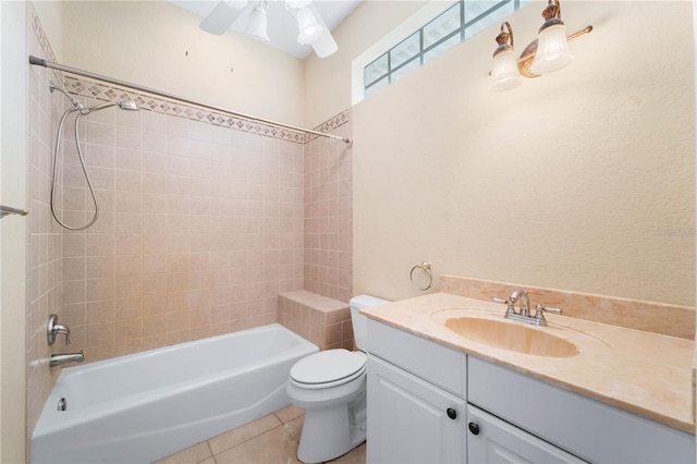 full bathroom featuring vanity, ceiling fan, toilet, and tiled shower / bath