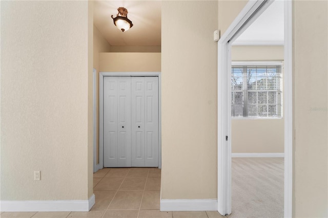 hallway featuring light tile floors