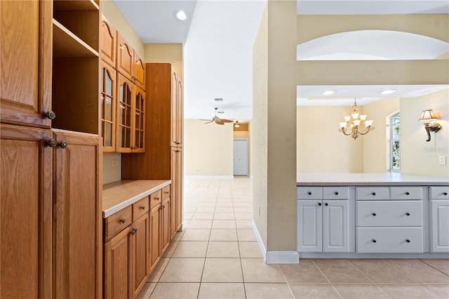 hall featuring a chandelier and light tile floors