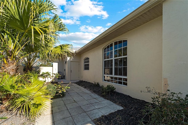 view of exterior entry featuring a patio