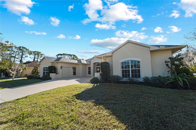 single story home featuring a front lawn and a garage