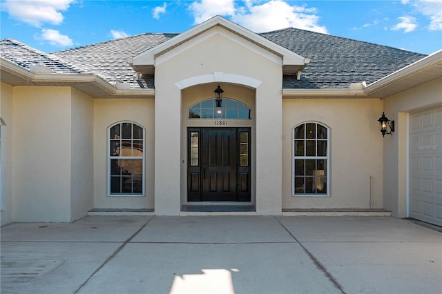 view of exterior entry with a garage