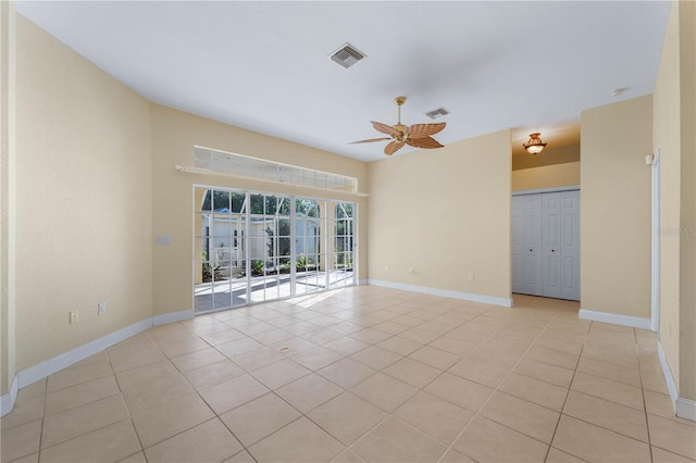 empty room featuring ceiling fan and light tile floors