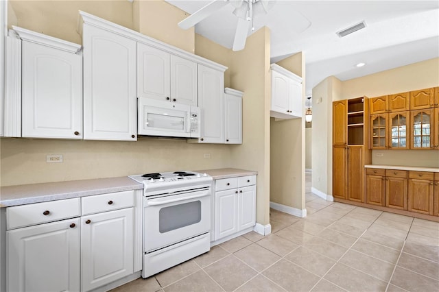 kitchen featuring white cabinets, light tile flooring, ceiling fan, and white appliances