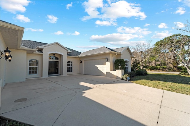 view of front of home featuring a front lawn and a garage