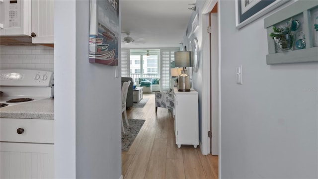 hallway with light hardwood / wood-style flooring