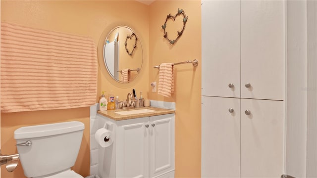 bathroom featuring oversized vanity and toilet