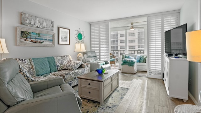 living room featuring ceiling fan and light hardwood / wood-style flooring