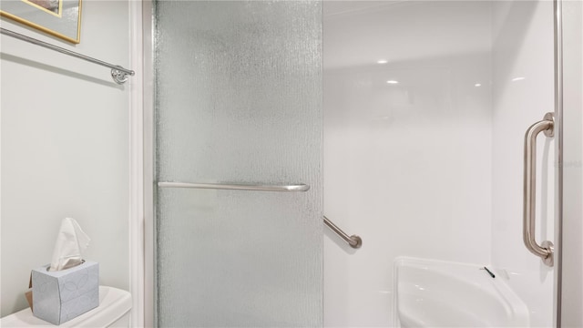 bathroom with toilet and an enclosed shower